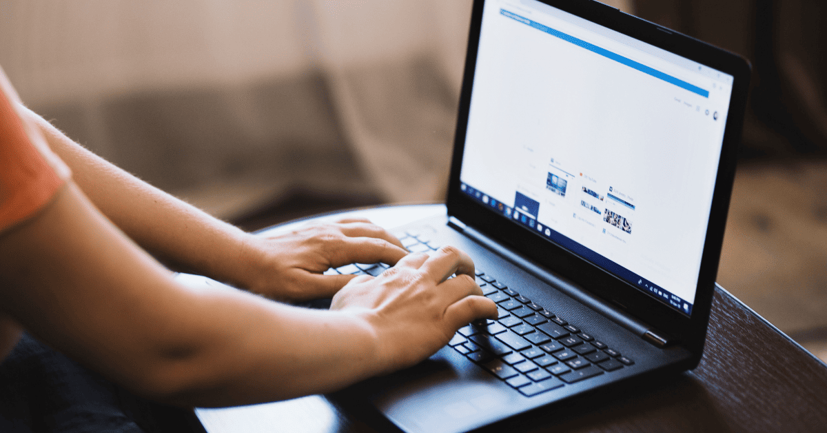 The Trend of AI Search. Person typing on a laptop.